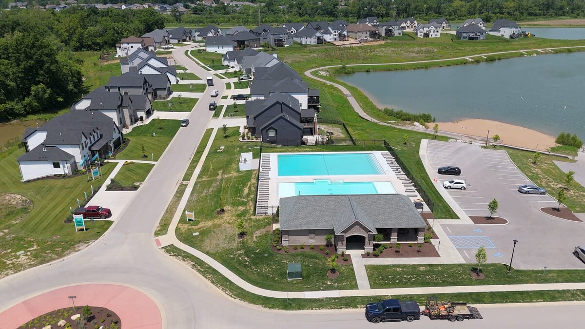Aerial view of the lake, clubhouse, and community pool at Cottleville Trails